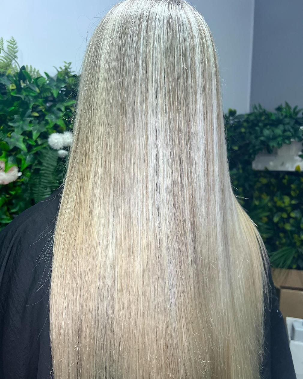 A Woman with Long Blonde Hair Is Standing in A Room — Losh Hair Lounge In Toowoomba City, QLD