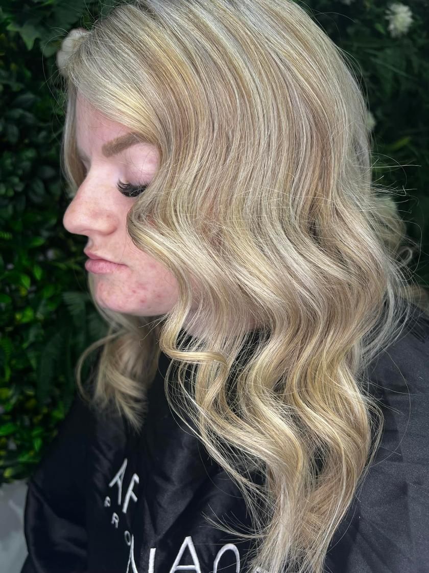 A Woman with Blonde Hair Is Wearing a Black Jacket — Losh Hair Lounge In Toowoomba City, QLD