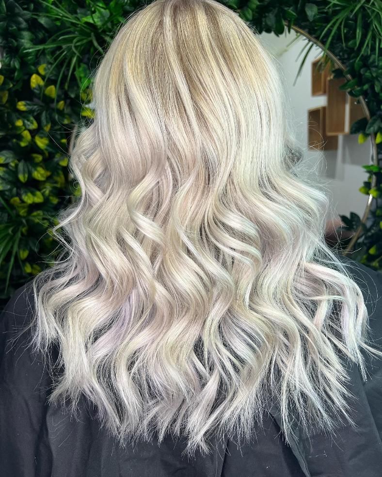 A Woman with Long Blonde Hair Is Sitting in Front of A Mirror — Losh Hair Lounge In Toowoomba City, QLD