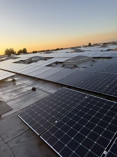 Workers installing solar panels on a tiled residential roof, using mobile storage racks and gear.