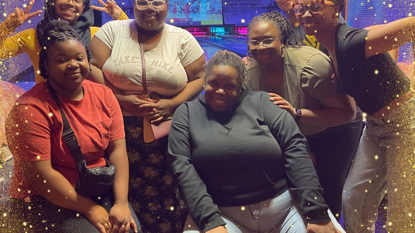 A group of women are posing for a picture together.