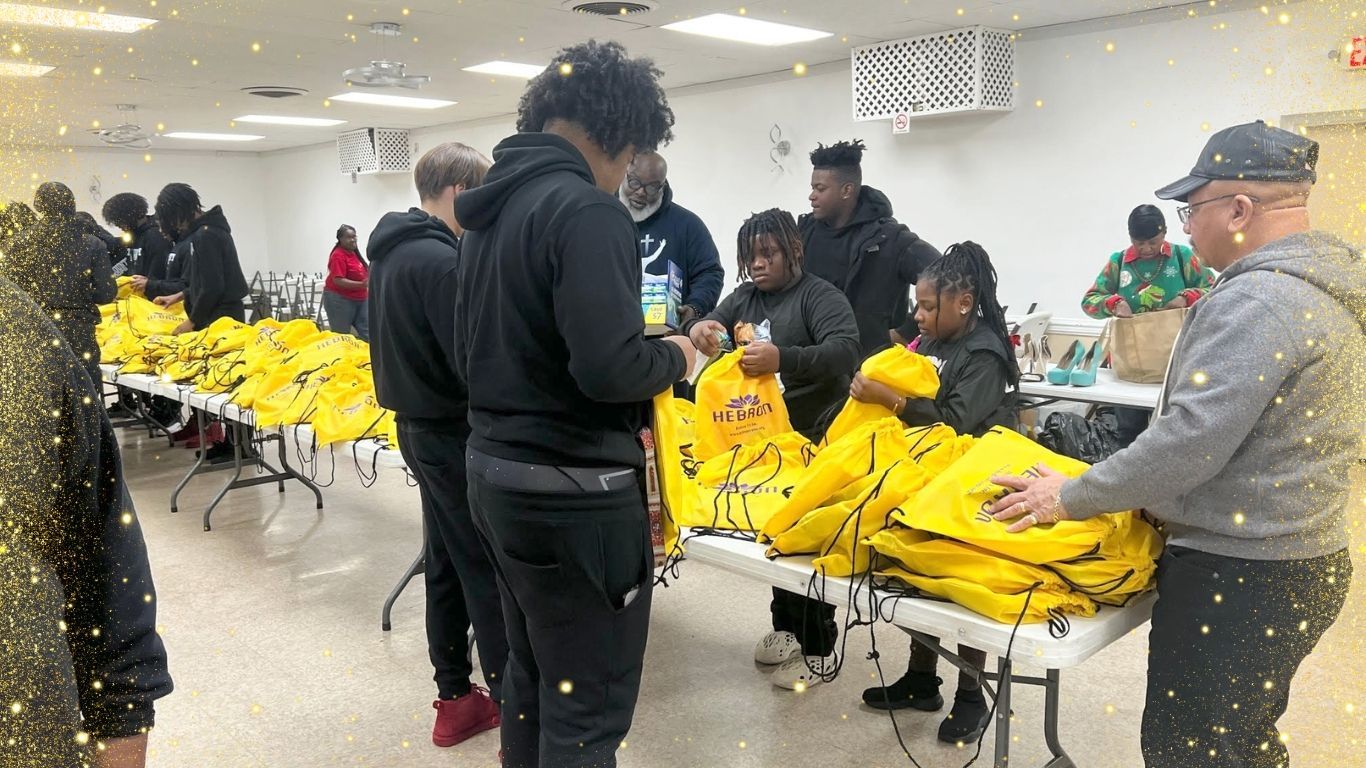 A group of people are standing around tables filled with yellow jackets.
