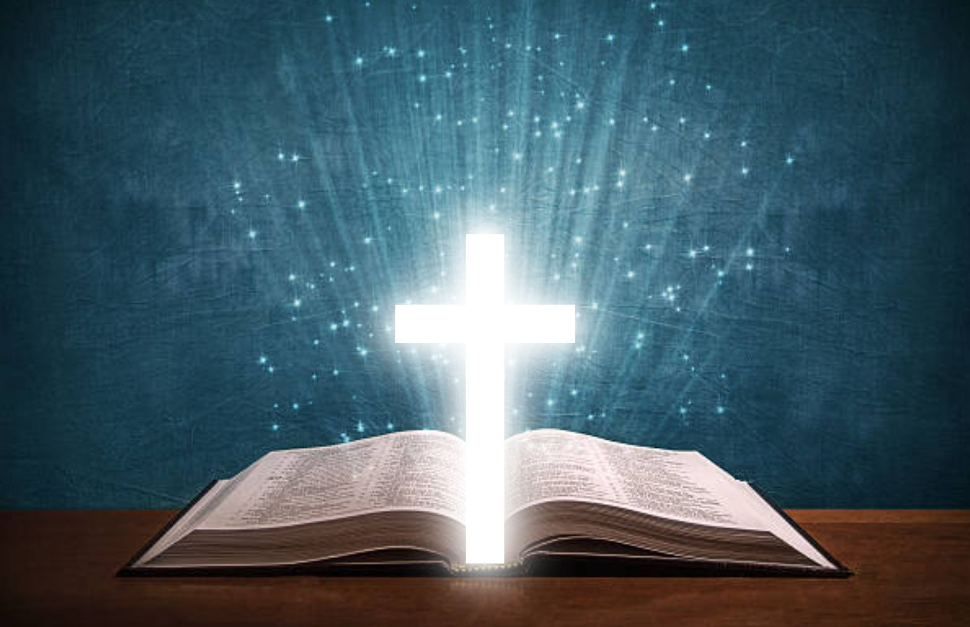 A person is praying with their hands up in front of a cross.