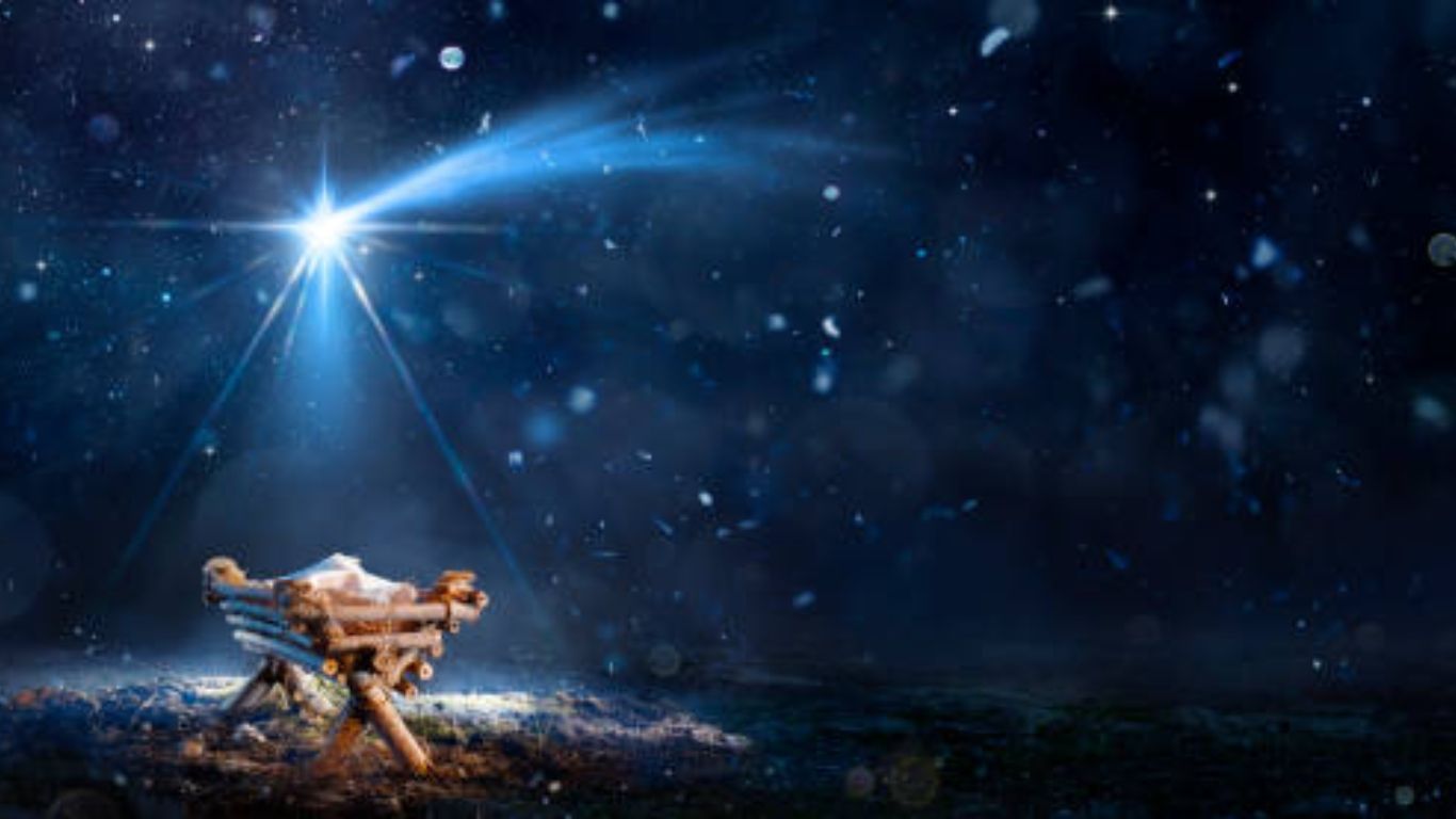 A person is praying with their hands up in front of a cross.