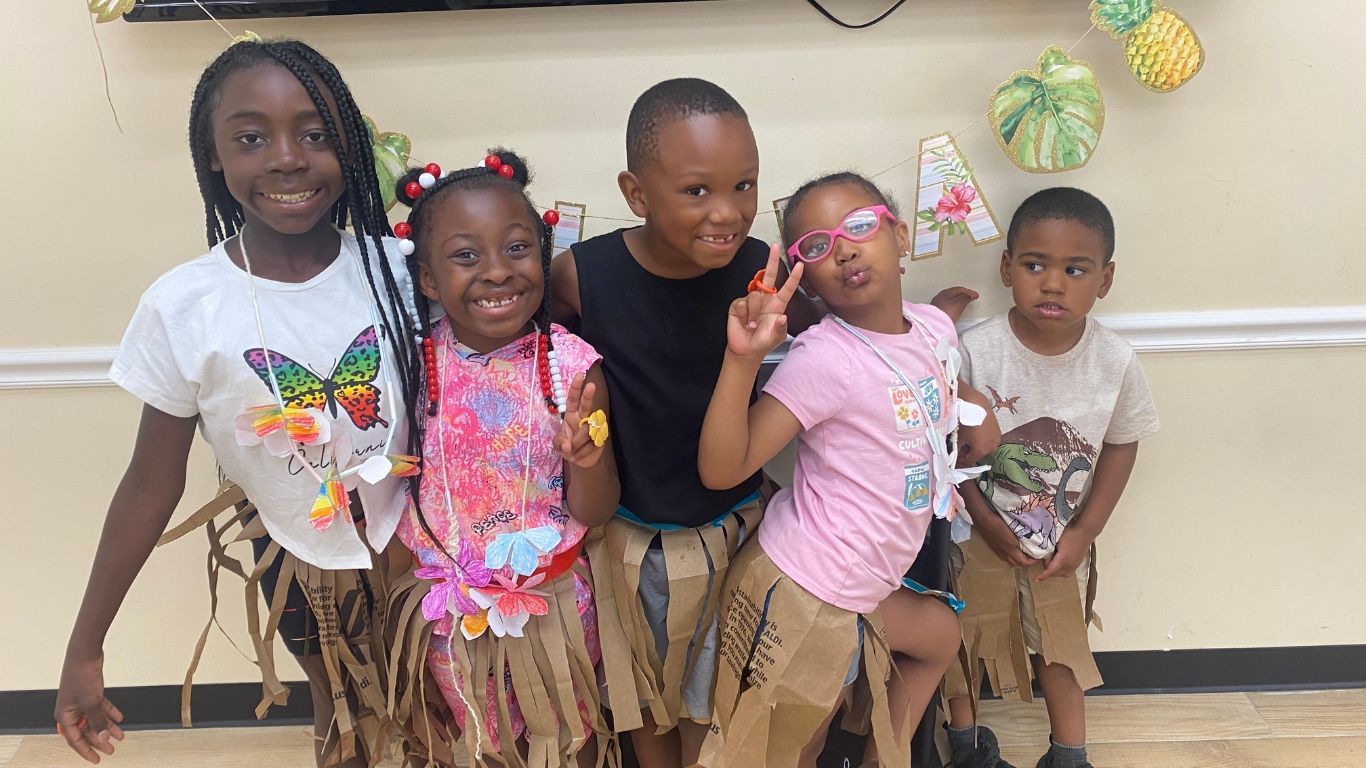 A group of children are posing for a picture in a room.