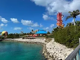 A water park with a water slide and a hot air balloon in the background.