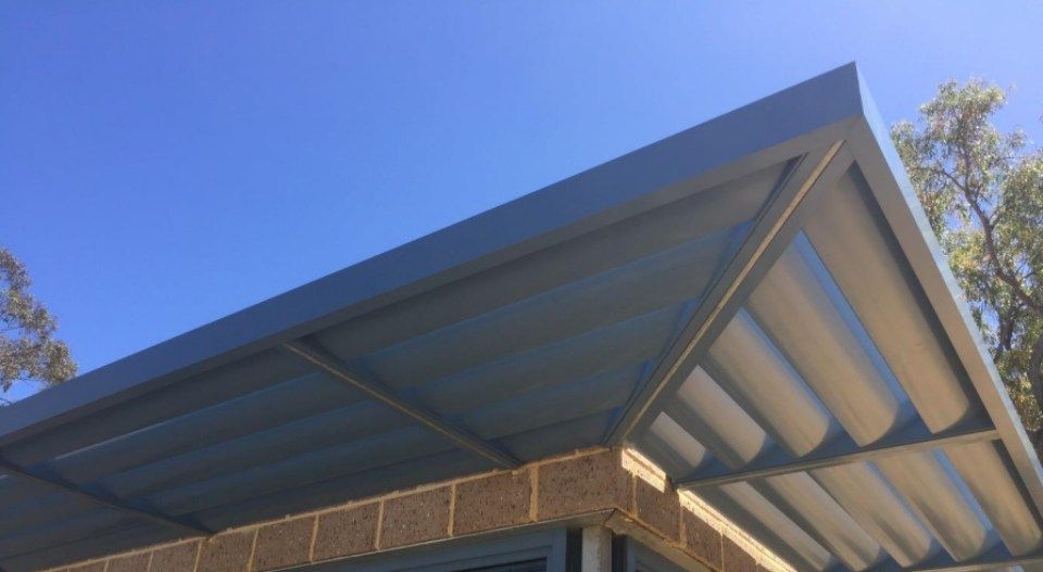 A roof of a building with a blue sky in the background.