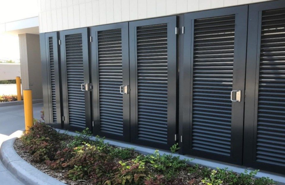 A row of black shutters on the side of a building.
