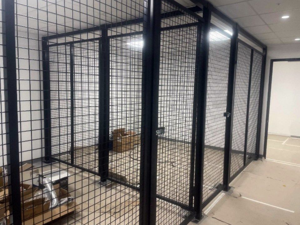 A room with a cage and a door in it