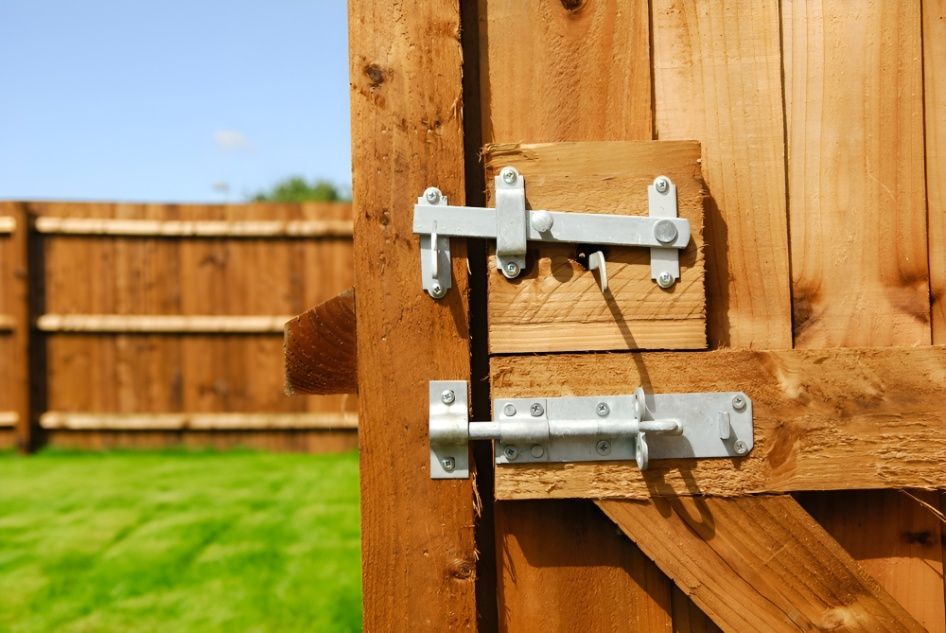 A Close Up of a Wooden Fence With a Latch on It — Mick's Carpentry & Maintenance In Machans Beach, QLD