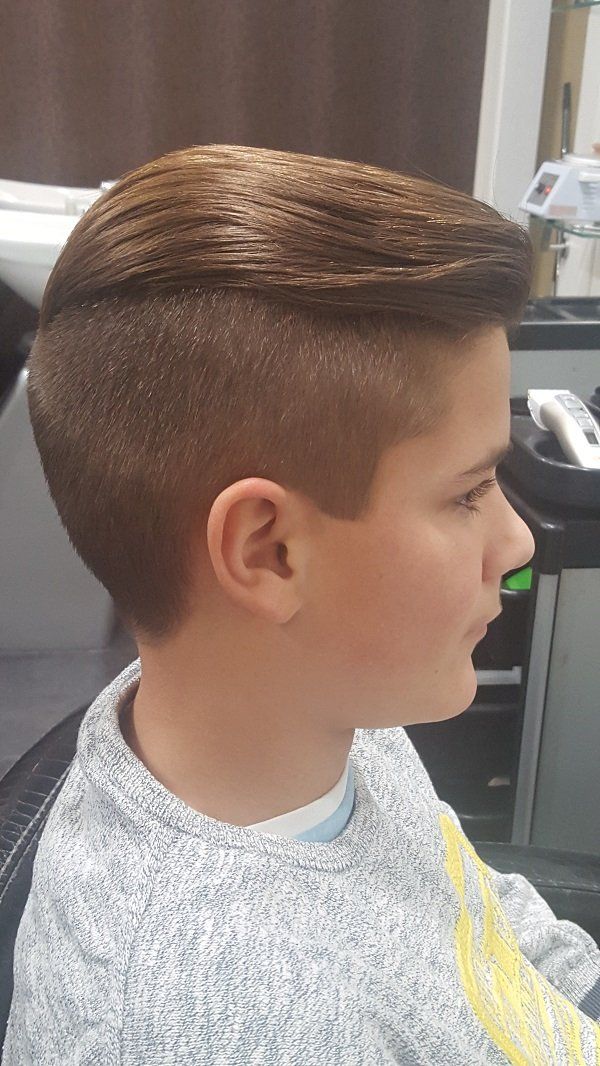 Un niño pequeño se está cortando el pelo en una barbería.