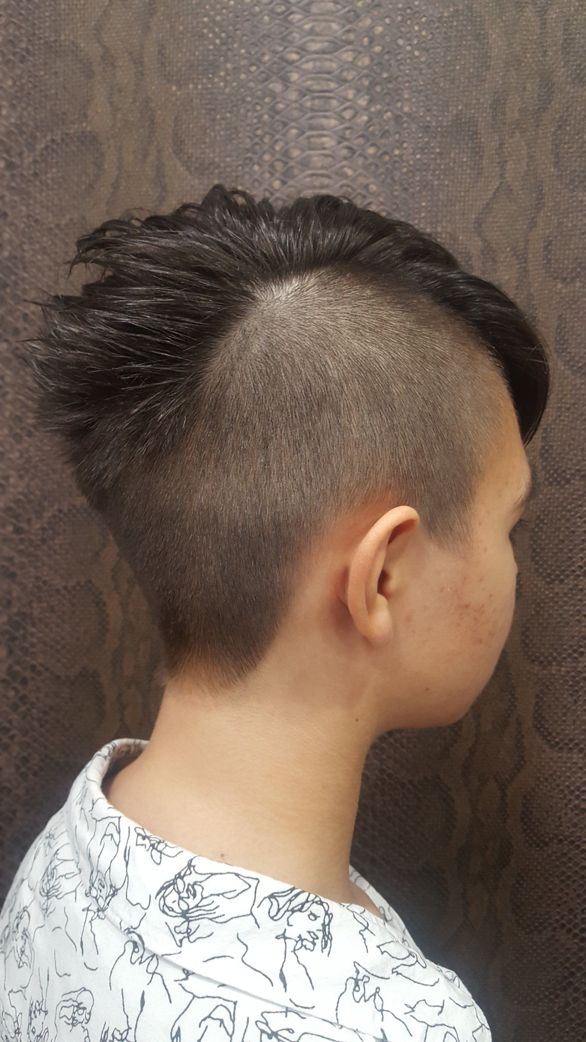 Un primer plano de la cabeza de una persona con un peinado mohawk.