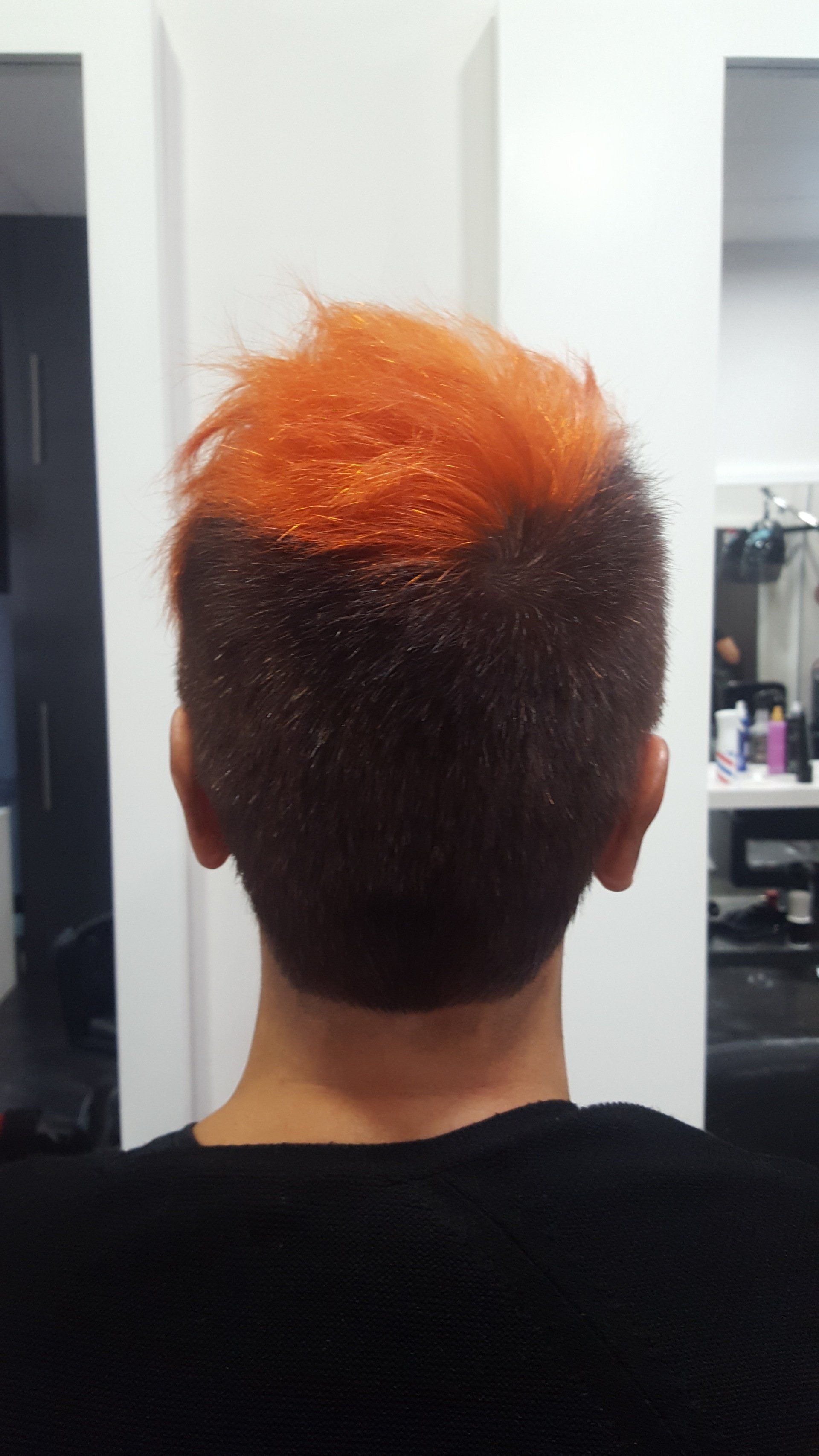 La parte posterior de la cabeza de una persona con cabello naranja.