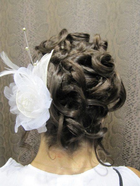 La parte posterior de la cabeza de una mujer con una flor en el pelo.