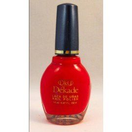 Una botella de esmalte de uñas rojo Dekade sobre una superficie blanca.