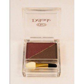 Dos tonos de sombra de ojos en una caja transparente con un pincel.