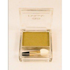 Una sombra de ojos verde en una caja transparente con un pincel.