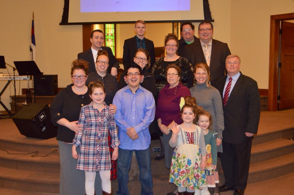 A group of people posing for a picture in a church