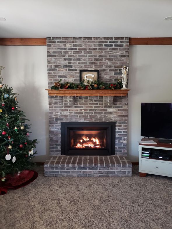A living room with a brick fireplace by JW Chimneys in Collegeville pa and surrounding areas.