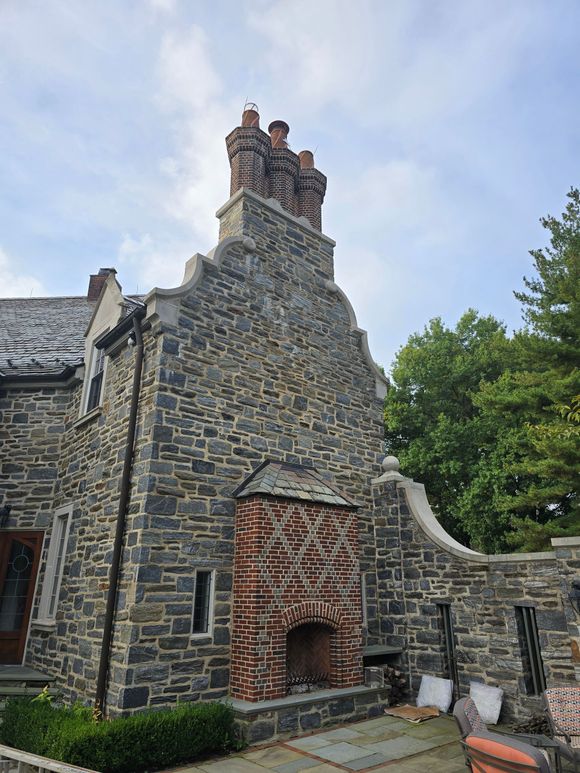 A large stone building with a chimney by JW Chimneys in Collegeville PA and surrounding areas.
