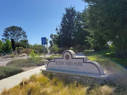 HWH San Diego Hard Money Lender - Real Estate emphasizes community living and investment appeal near Buddy Todd Park in Oceanside. The image showcases open grassy fields, shaded picnic areas, and scenic coastal views that highlight the family-friendly lifestyle of the neighborhood.