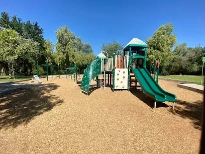 HWH San Diego Hard Money Lender - Real Estate emphasizes community living and property appeal near Kit Carson Park in Escondido. The image highlights wide open green spaces, sports fields, scenic walking trails, and family-friendly recreation areas that showcase the city’s lifestyle benefits.