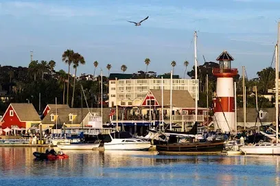 HWH San Diego Hard Money Lender - Real Estate showcases the coastal charm and investment appeal of Oceanside Harbor Village. The image captures the marina, waterfront shops, and vibrant dining spots that make this seaside destination unique.