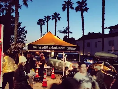 HWH San Diego Hard Money Lender - Real Estate highlights the community vibrancy and real estate appeal of the Oceanside Sunset Market. The image captures lively street vendors, food stands, live music, and crowds enjoying the coastal evening atmosphere.