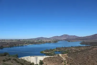 HWH San Diego Hard Money Lender - Real Estate highlights the natural beauty and investment appeal of areas near Otay Lakes County Park. The image captures serene lake views, open green spaces, and peaceful outdoor settings that showcase the lifestyle benefits of living in the region.