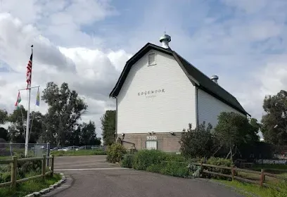 HWH San Diego Hard Money Lender - Real Estate highlights cultural heritage and investment potential near the Santee Historical Society and Historic Barn. The image showcases a preserved historic barn, educational exhibits, and displays that reflect the city’s rich history.