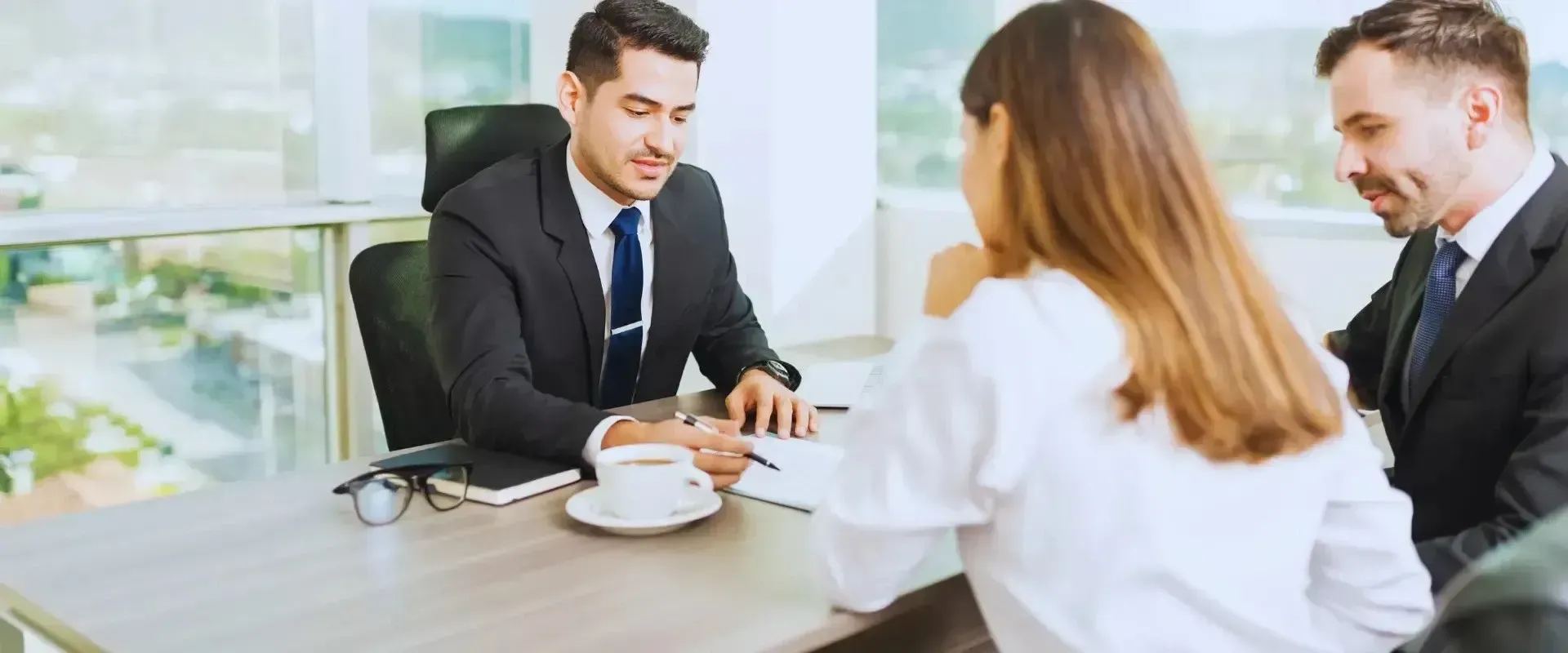 HWH San Diego Hard Money Lender - Real Estate shows a professional man in a suit and tie talking with his client in an office setting. The business environment reflects trust, professionalism, and the importance of clear communication in real estate lending.