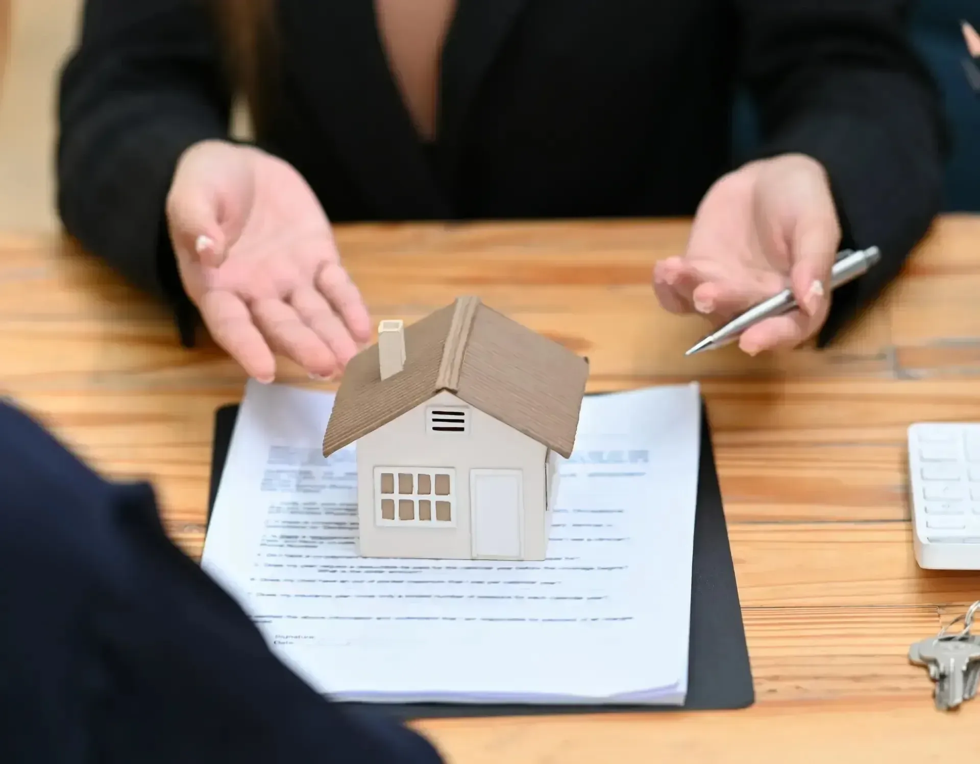 San Diego Hard Money Lender - The image shows a real estate professional discussing loan terms with a client, symbolizing smooth and efficient funding solutions.