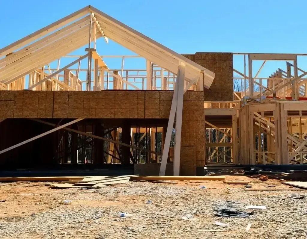 San Diego Hard Money Lender - The image shows a wooden house frame under construction, highlighting financing options for builders and investors.