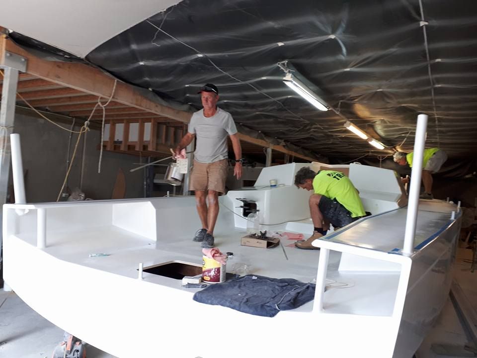 Two Men Are Working on a Boat in a Building — Off Shore Sails & Rigging In North Boambee Valley, NSW