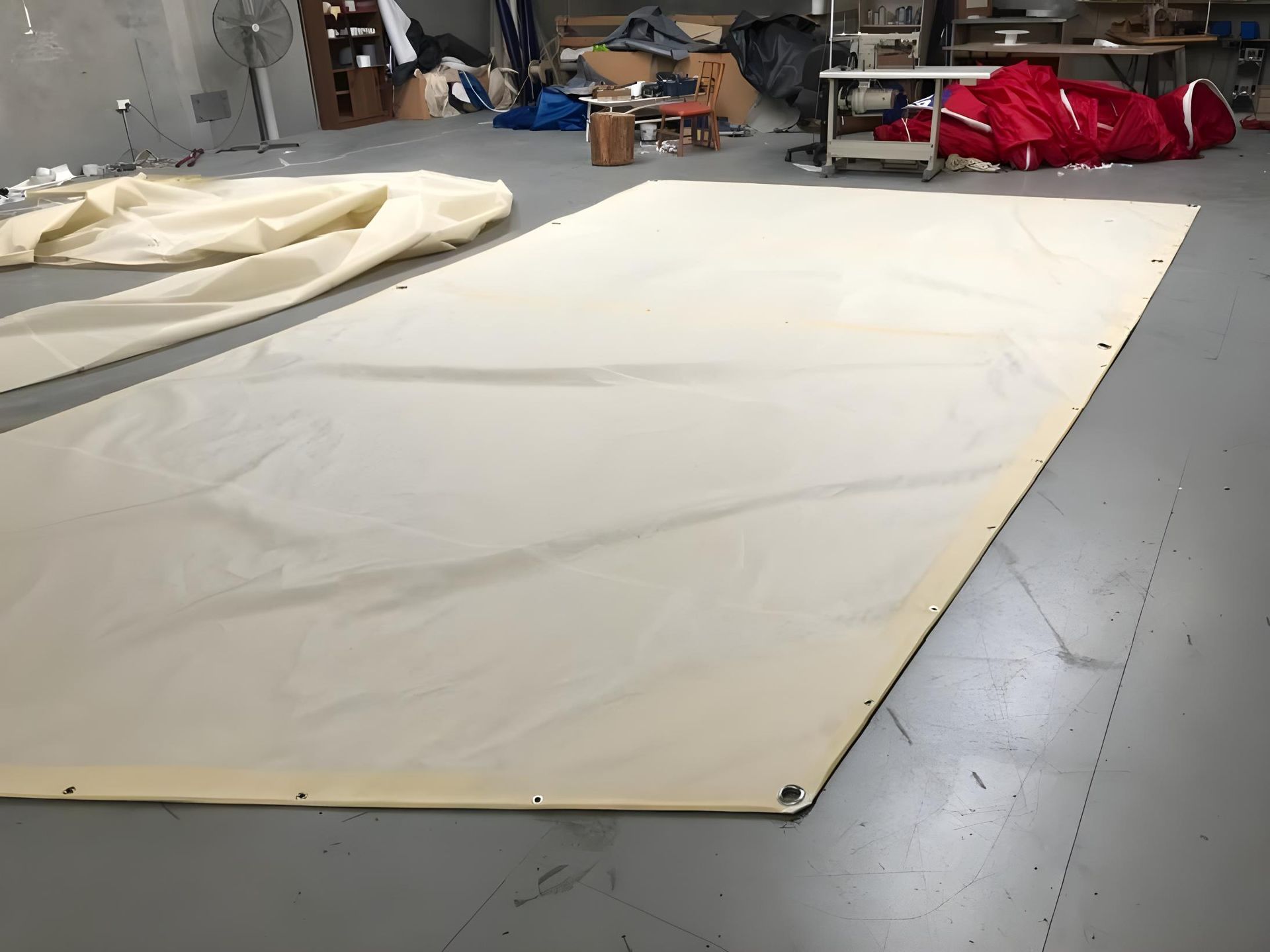 A Man is Measuring a Piece of Paper in a Room — Off Shore Sails & Rigging In North Boambee Valley, NSW