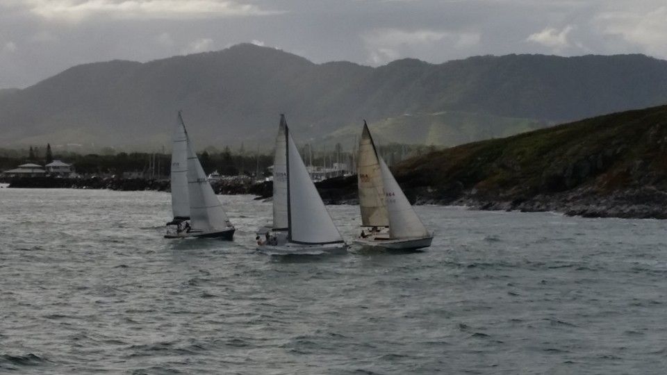 Three Sailboats Are Floating on Top of a Body of Water — Off Shore Sails & Rigging In North Boambee Valley, NSW