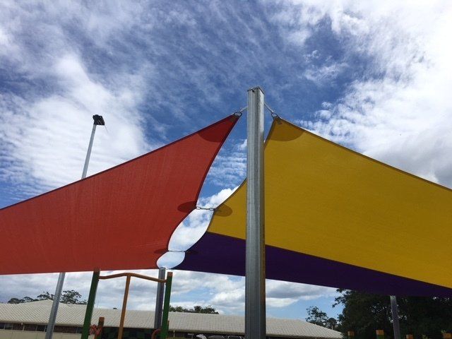 A Red Yellow and Purple Umbrella With a Blue Sky in the Background — Off Shore Sails & Rigging In North Boambee Valley, NSW
