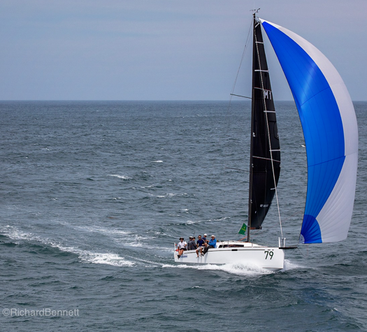 A Group of Men Are Standing Around a Boat in a Parking Lot — Off Shore Sails & Rigging In North Boambee Valley, NSW