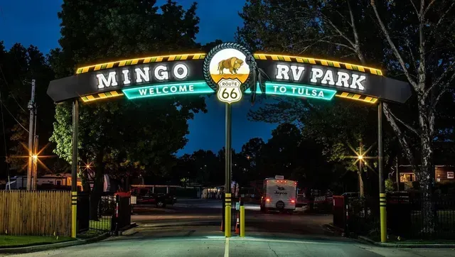The entrance to mingo rv park is lit up at night