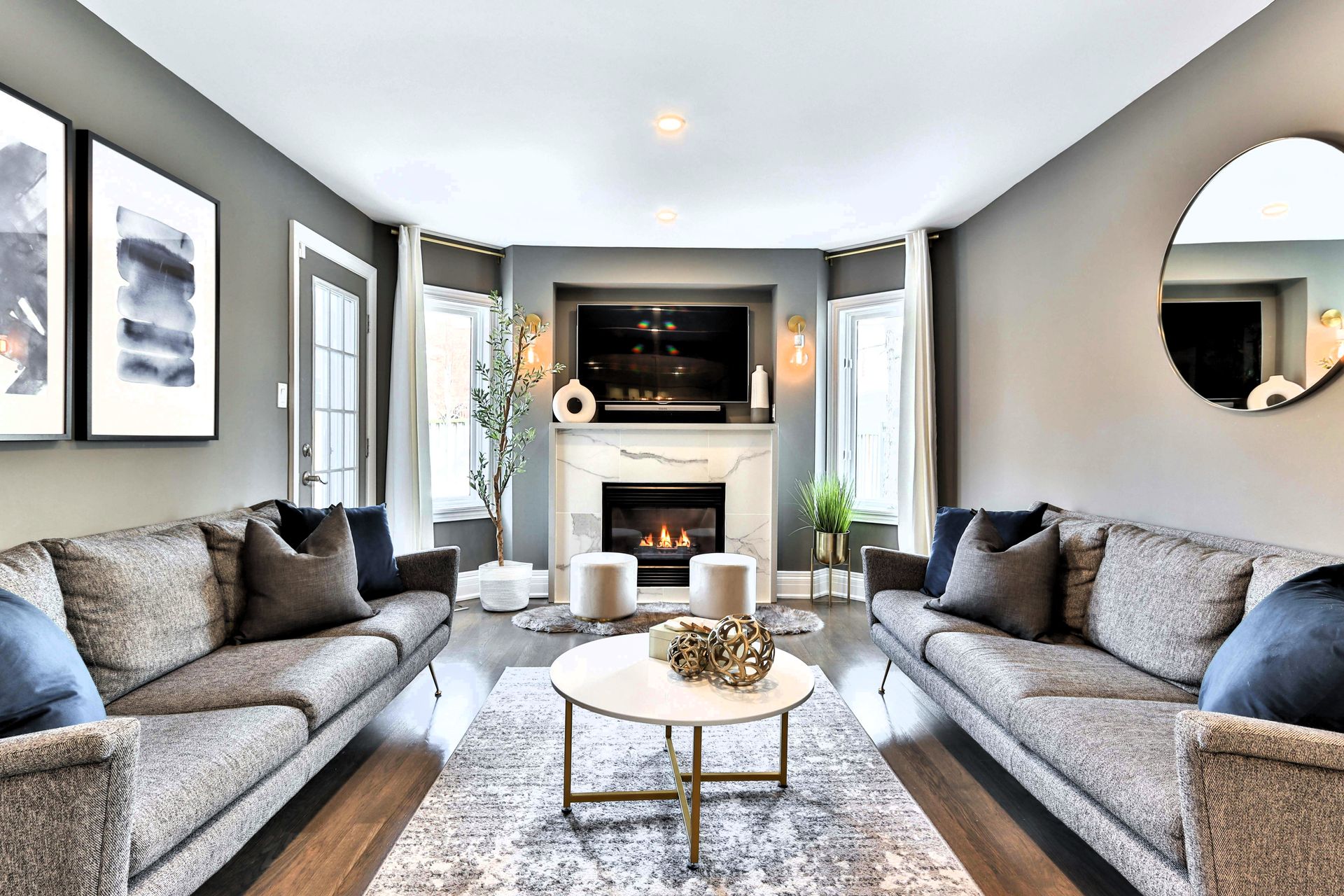 Gray couch near white fireplace in modern living space