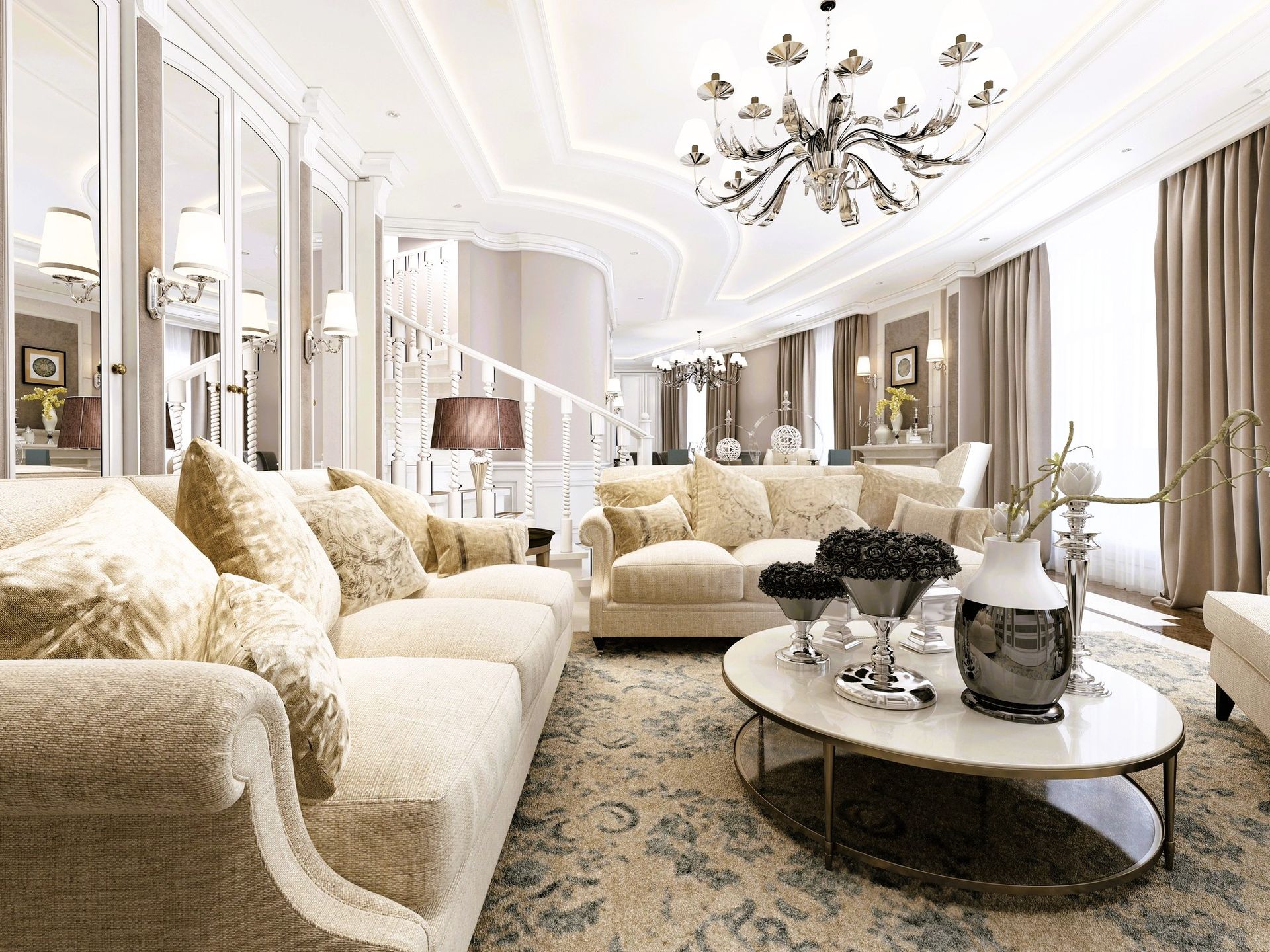 Luxurious living room with elegant sofas, ornate chandelier, and a grand staircase.