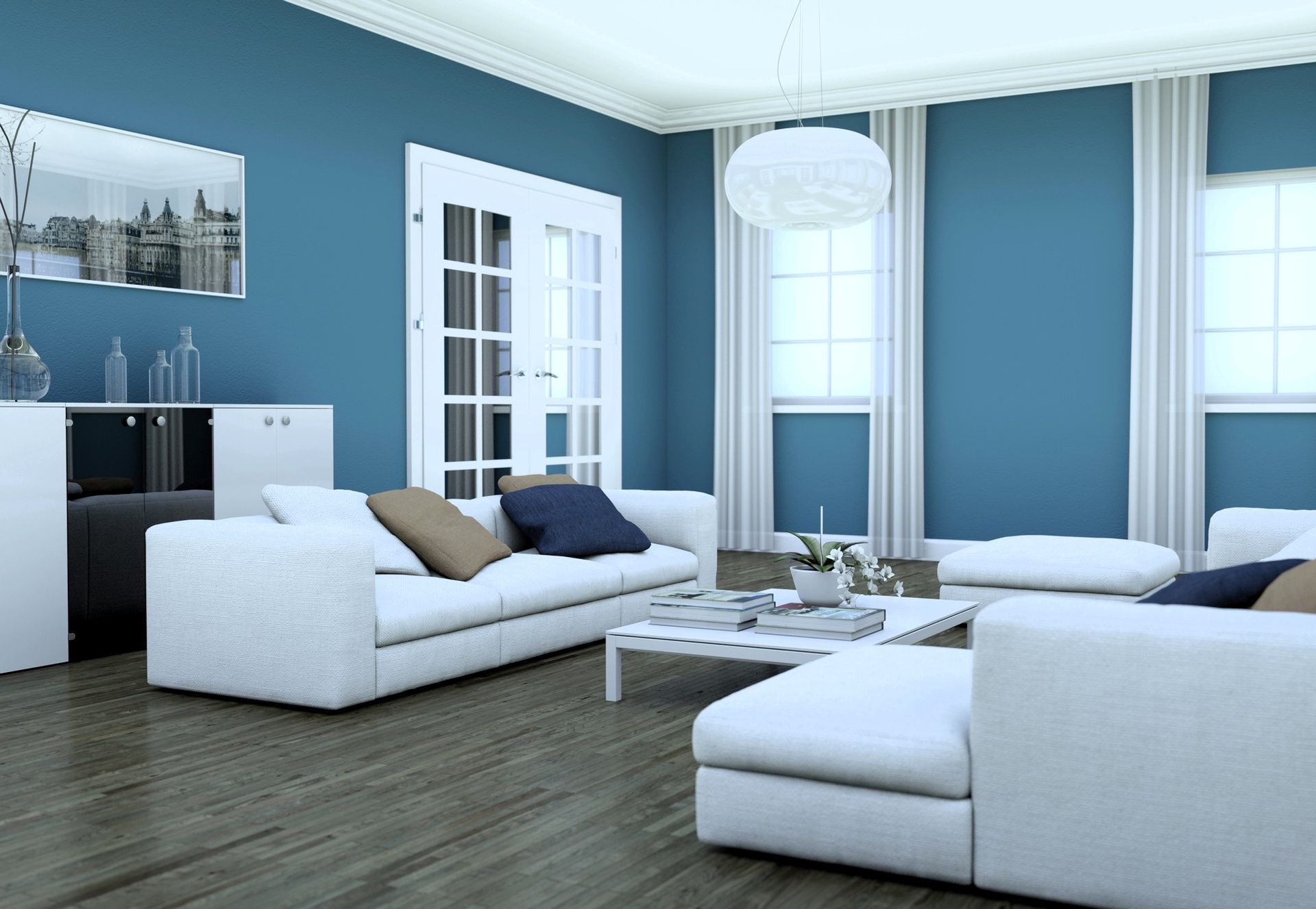 Modern living room with white sofas, coffee table, and blue accent wall in a bright