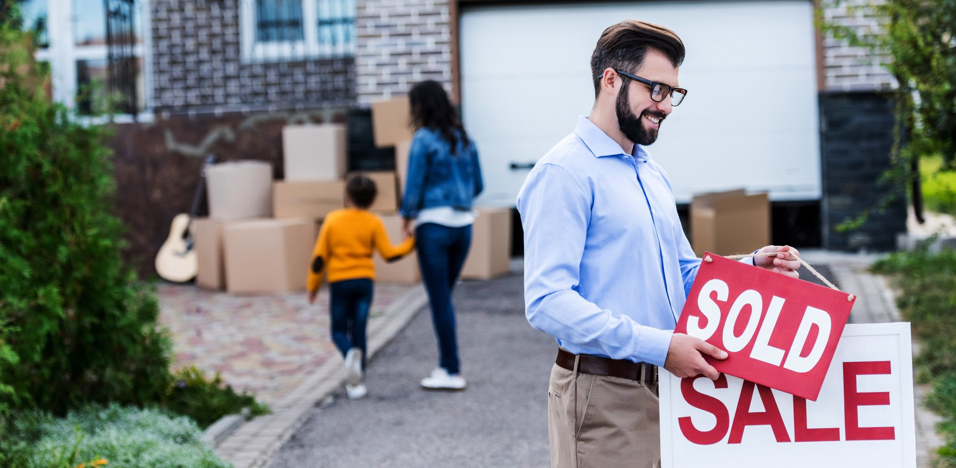 agent putting the sold sign