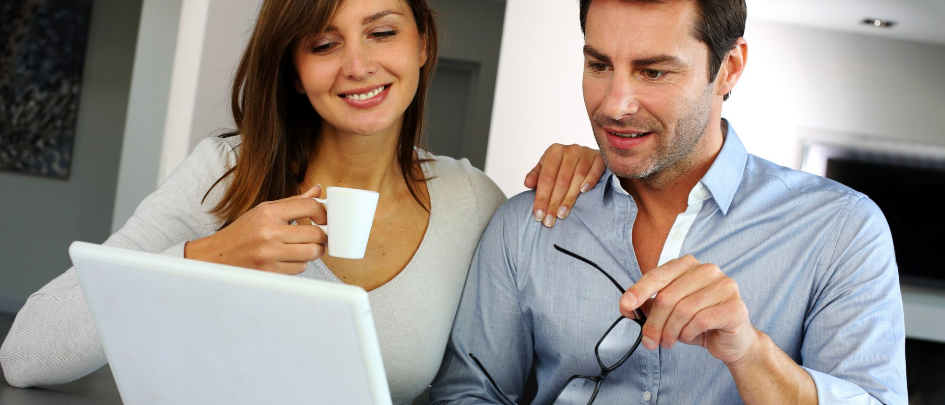 young couple planning a home remodel on their laptop