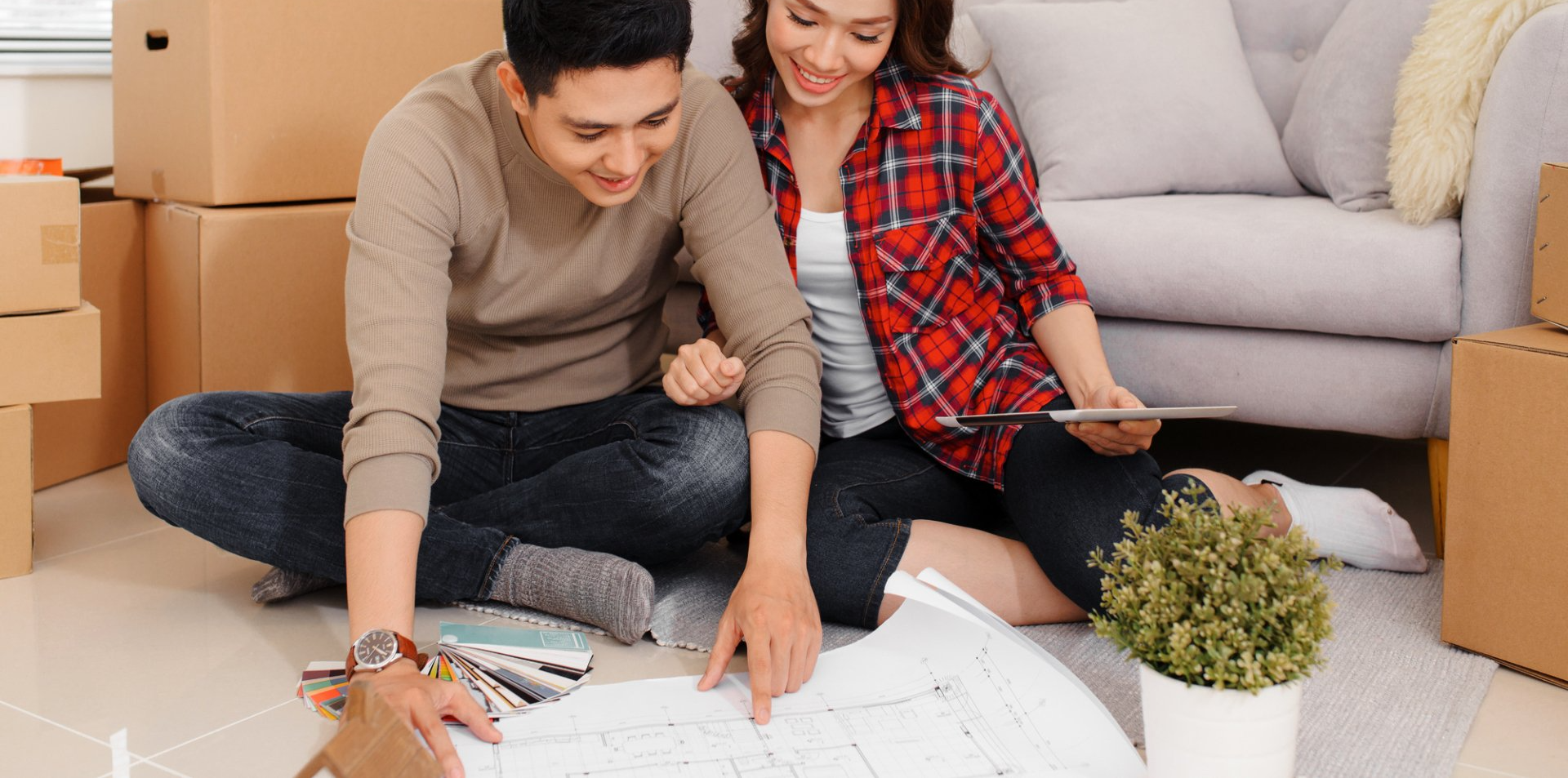 young couple looking at blue prints for the renovation