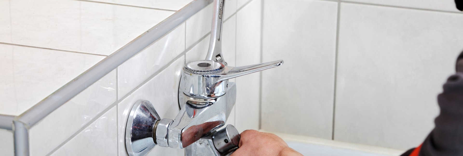 man fixing  an old faucet