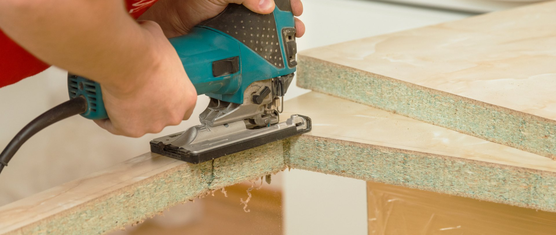 man sawing a space for his sink