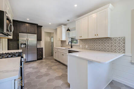completed modern kitchen remodel with stainless steel appliances, tile floor and backsplash, and custom white cupboards