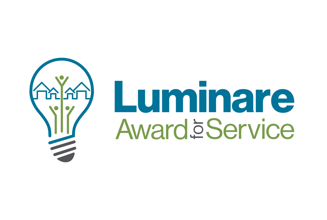 A logo for luminare award service with a light bulb and trees.