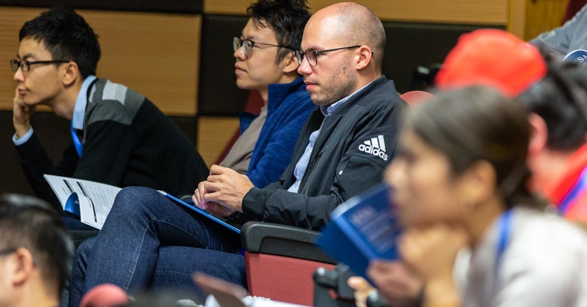 A group of people are sitting in a lecture hall.